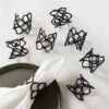 Basal Satin Black Napkin Rings Set Of 8 1 Basal Satin Black Napkin Rings Set Of 8 -Cb2 BasalStnBlackNpknRingS8SHF22