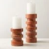 Dev Red Travertine Candle Holders 2 Dev Red Travertine Candle Holders -Cb2 DevRedTrvrtnPillarHldrGrpAVFHS22